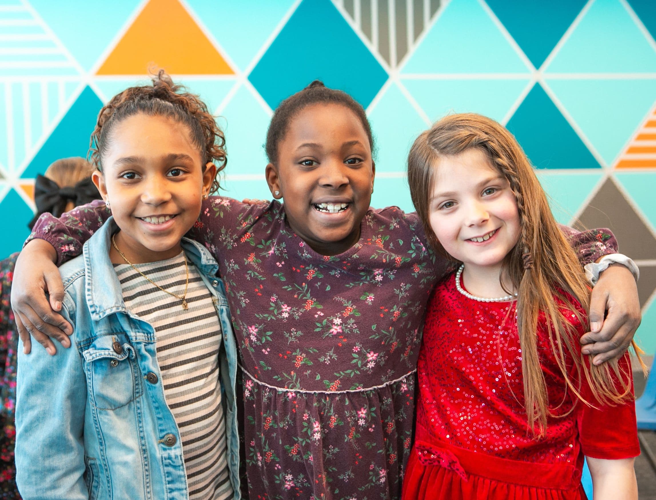 Three girls smiling.